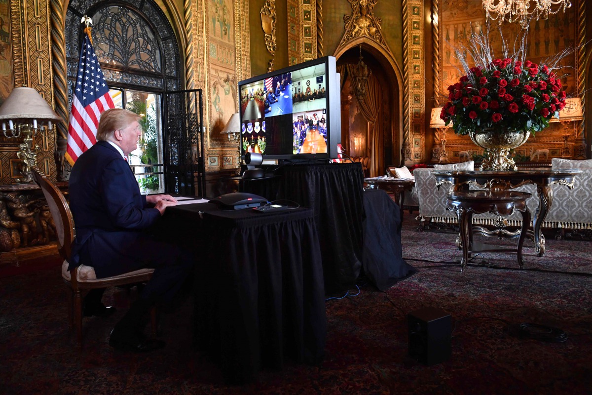 US President Donald Trump makes a video call to the troops stationed worldwide at the Mar-a-Lago estate in West Palm Beach Florida, on December 24, 2019. AFP / Nicholas Kamm
 