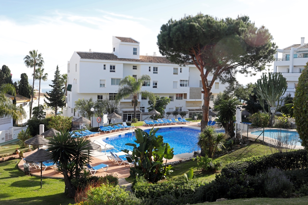 A general view of a swimming pool where three members of the same British family, a father and two children, were found on Christmas Eve at a Costa del Sol resort in Las Lagunas de Mijas, southern Spain December 25, 2019. Reuters/Jon Nazca
 
