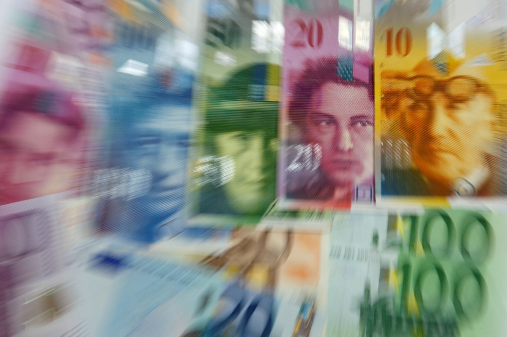 FILE PHOTO: Various Euro banknotes lay next to various Swiss Franc notes in this picture illustration at a bank in Warsaw, July 18, 2011. Reuters / Kacper Pempel
