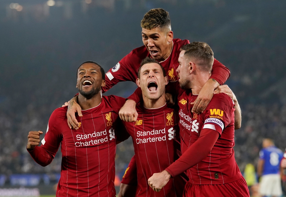 Liverpool's James Milner celebrates scoring their second goal with teammates (REUTERS/Andrew Yates)