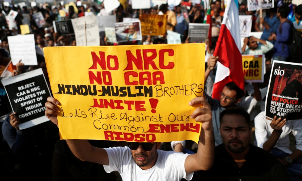 Demonstrators hold placards during a protest against a new citizenship law in Mumbai, India, December 27, 2019. Reuters/Francis Mascarenhas