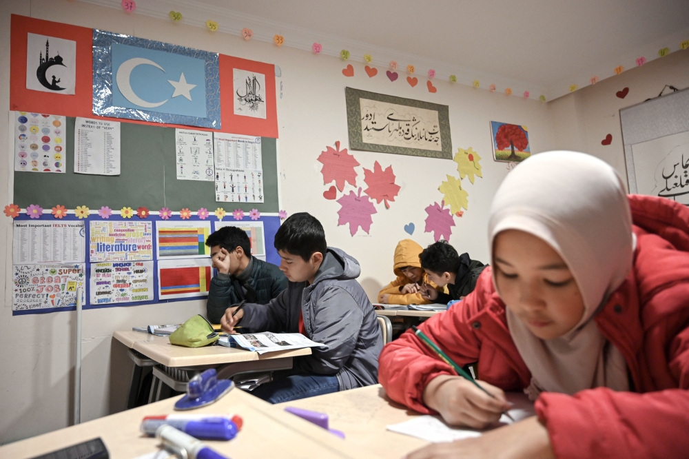 Uighur childen attend a science lesson in a school of Silivri district in Istanbul on November 29, 2019. AFP / Ozan Kose 