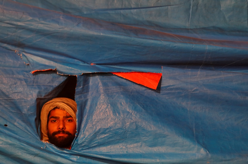 A demonstrator listens to a speaker during a protest against a new citizenship law, in New Delhi, India, December 31, 2019. Reuters/Adnan Abidi