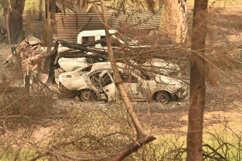 Cars destroyed by bushfires are seen in Mogo near Batemans Bay in New South Wales on January 2, 2020. AFP / PETER PARKS