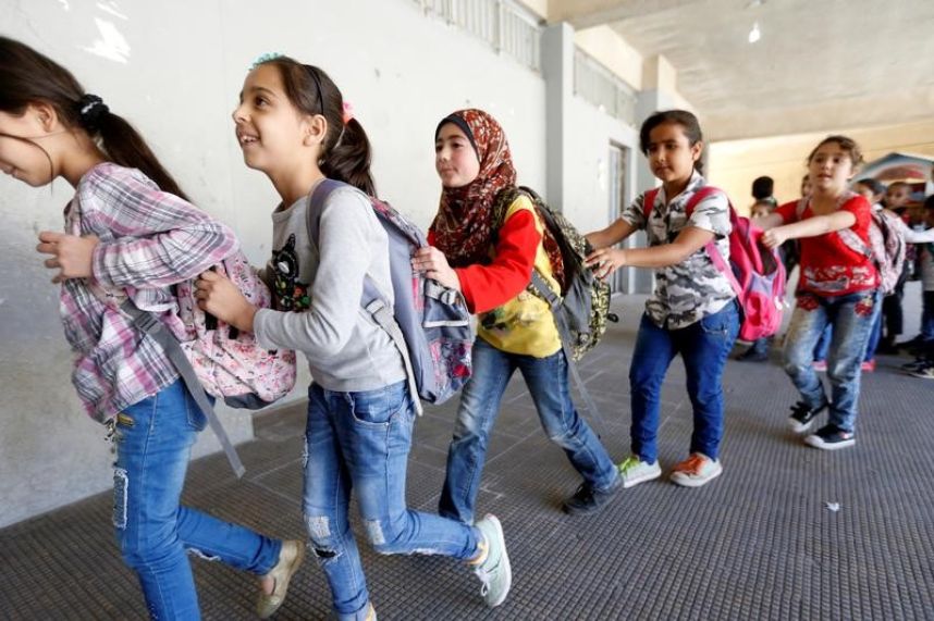 Syrian refugee children queue as they head towards their classroom at a school in Mount Lebanon, October 7, 2016. Reuters / Mohamed Azakir