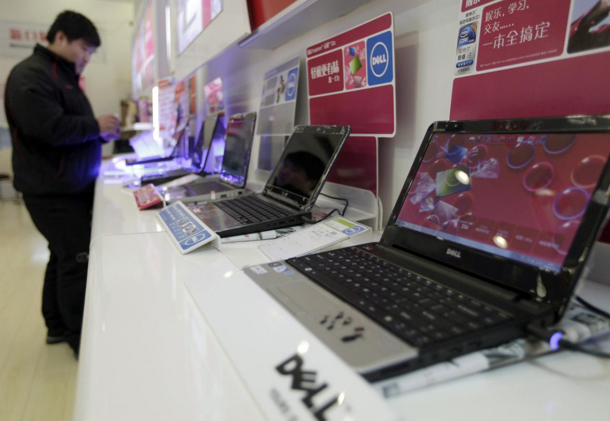 A customer looks at laptops at a Dell outlet in Beijing December 13, 2010. Reuters/Christina Hu
