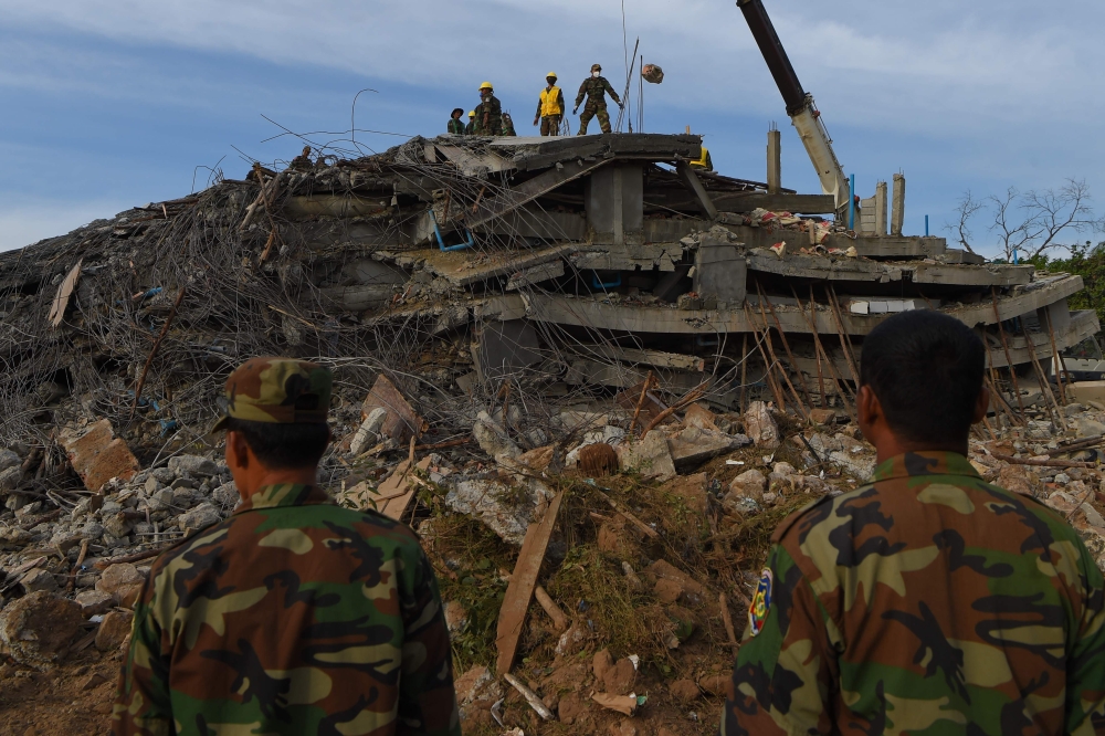 Rescue personnel work at the site where an under-construction building on January 3 collapsed, trapping and killing workers, in southern Cambodia's coastal Kep province on January 4, 2020. Hundreds of soldiers and rescuers frantically picked through the r