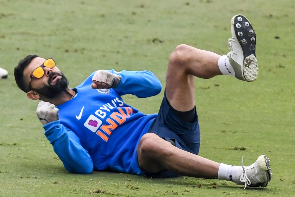 India's captain Virat Kohli stretches as he attends a training session ahead of the first T20 international cricket match of a three-match series between India and Sri Lanka, at the Assam Cricket Association Stadium in Barsapara in Guwahati on January 4, 