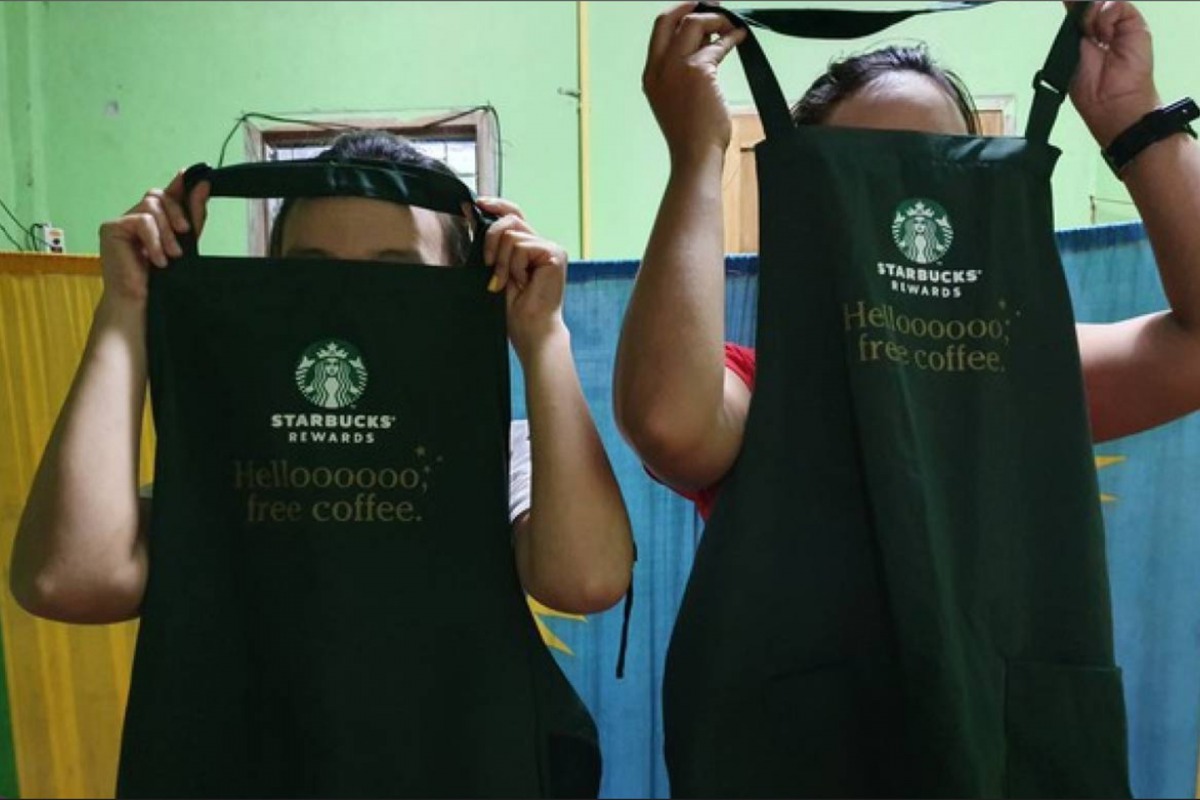 Workers show Starbucks aprons at a dormitory near a factory in Mae Sot district, Thailand in August 2019. Thomson Reuters Foundation / Nanchanok Wongsamuth