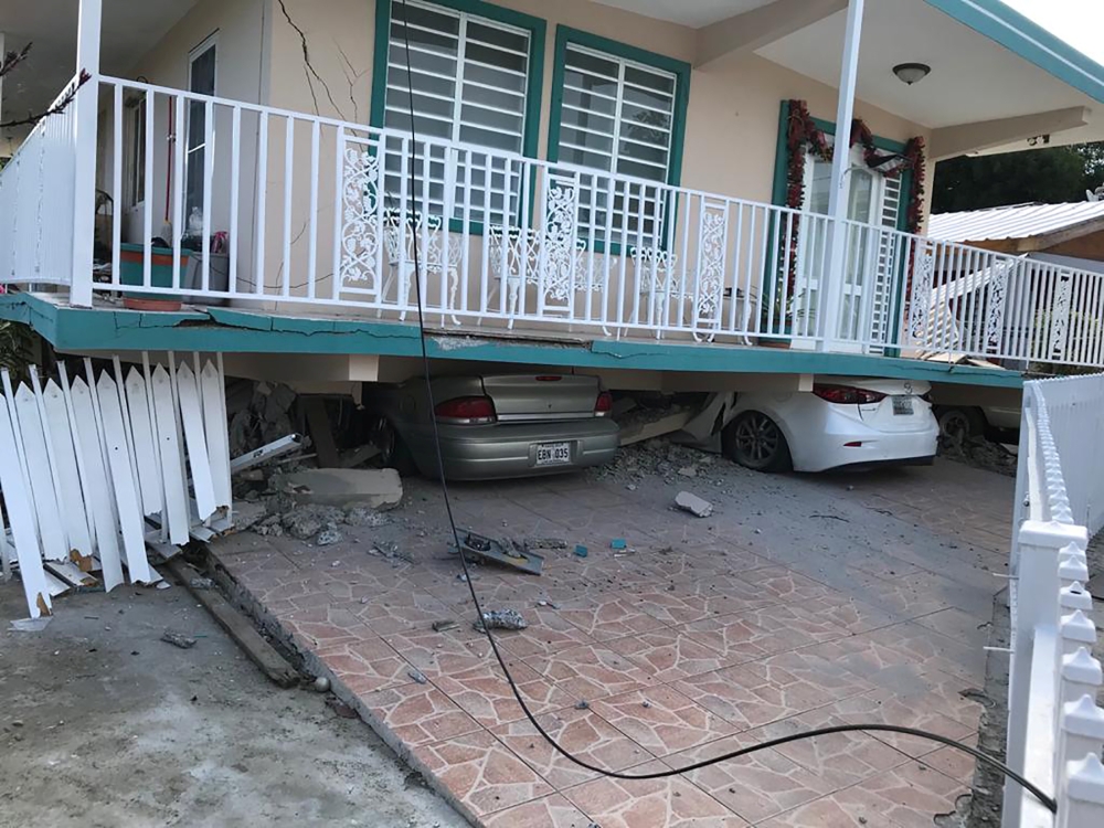 Cars lie under a collapsed house after an earthquake in Guanica, Puerto Rico January 6, 2020. Reuters/Ricardo Ortiz