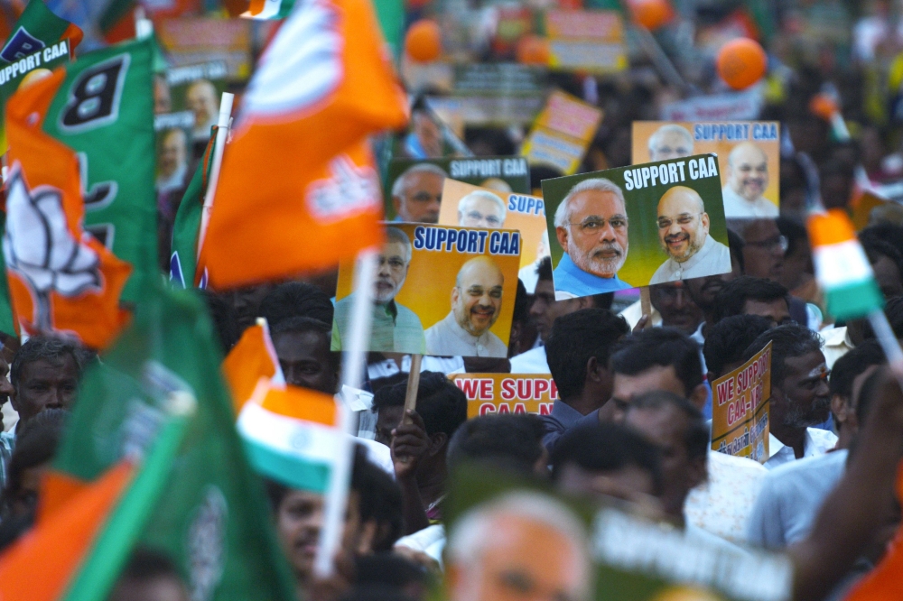 Supporters of the Bharatiya Janata Party (BJP) wave party flags and hold placards in support of the government's Citizenship Amendment Act (CAA) and the National Register of Citizens (NRC) during a rally in Chennai on January 7, 2020. Protests were held a