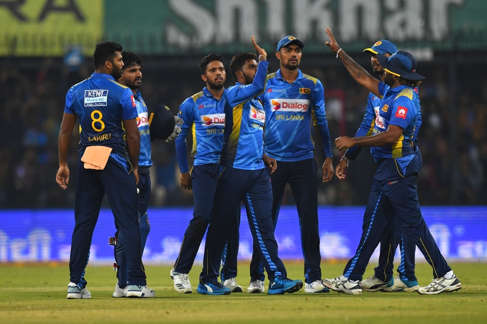 Sri Lanka's team celebrate the wicket of India's K. L. Rahul (unseen) during the second T20 international cricket match of a three-match series between India and Sri Lanka at the Holkar Cricket Stadium in Indore on January 7, 2020. / AFP / Indranil MUKHER