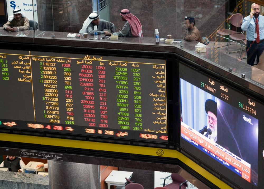 Iran's Supreme Leader Ayatollah Ali Khamenei is seen speaking on a TV screen in the Kuwait Bourse (Stock Exchange), as investors sit and monitor the shares in Kuwait City, Kuwait. January 8, 2020. Reuters/Stephanie McGehee 