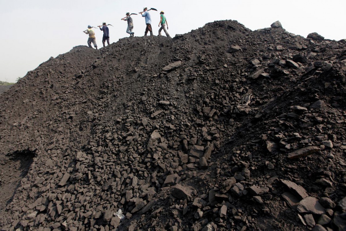 Workers walk on a heap of coal at a stockyard of an underground coal mine in the Mahanadi coal fields at Dera near Talcher town in Orissa state, India March 28, 2012. Reuters / Rupak De Chowdhuri