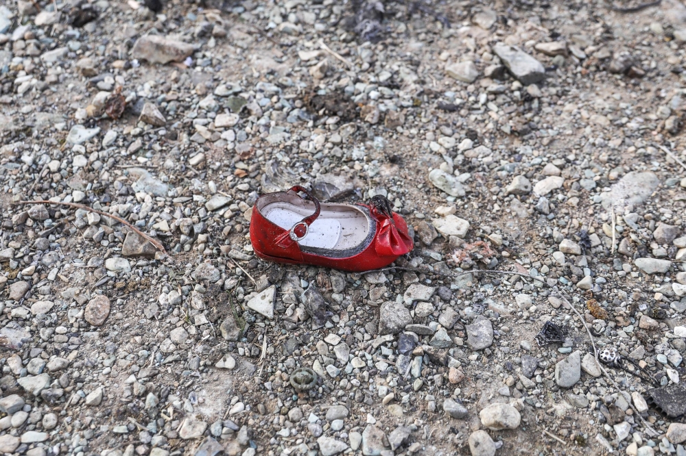 A child's shoe is pictured on January 8, 2020 at the scene of a Ukrainian airliner that crashed shortly after take-off near Imam Khomeini airport in the Iranian capital Tehran. AFP / ISNA / Borna Ghassemi
 
 
