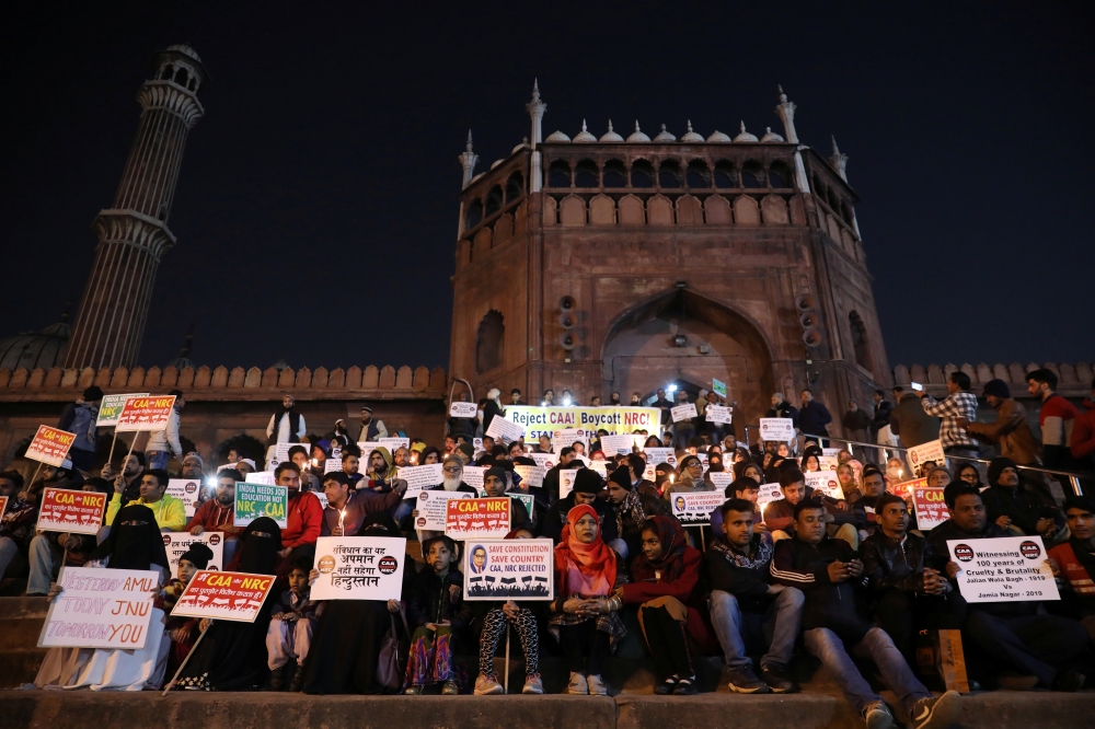 Demonstrators carry placards and hold candles during a silent protest against a new citizenship law at Jama Masjid, in the old quarters of Delhi, India, January 10, 2020. Reuters/Anushree Fadnavis
 