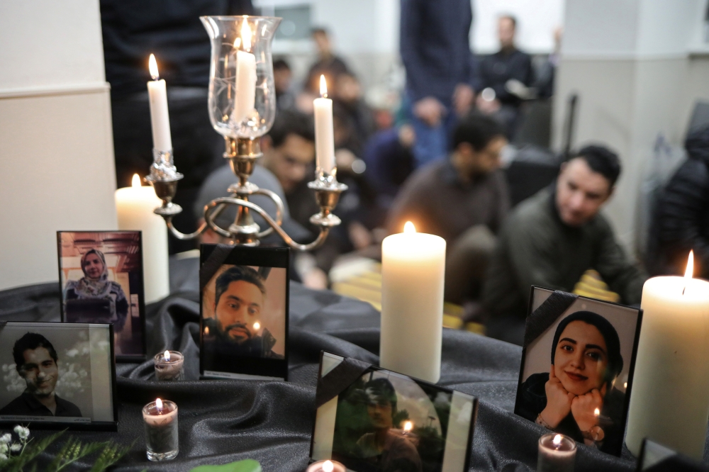 Photographs of student victims of a Ukrainian passenger jet which crashed in Iran are seen during a vigil at University of Toronto student housing in Toronto, Ontario, Canada January 8, 2020. Reuters/Chris Helgren