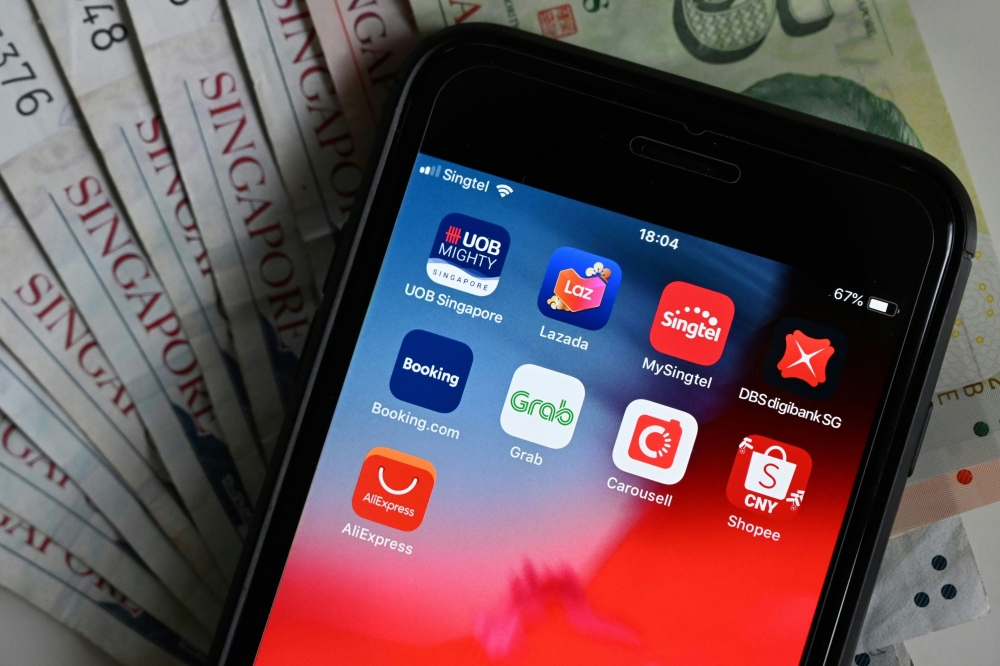 This illustration photograph taken on January 9, 2020 shows banking and purchasing apps on a smartphone in Singapore. AFP / Roslan Rahman 