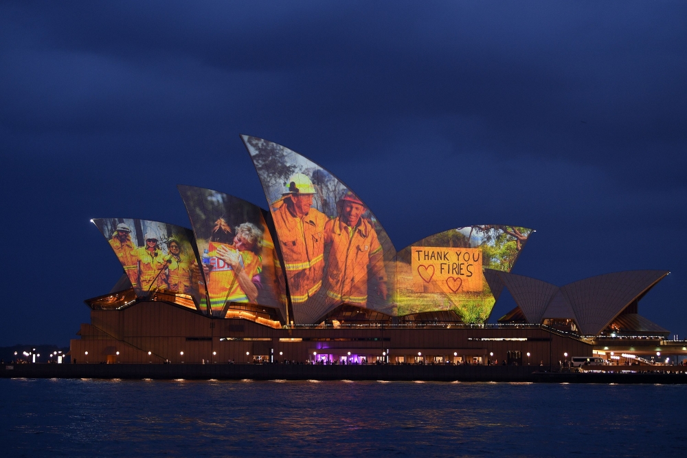 The sails of the Opera House are lit with a series of images to show support for the communities affected by the bushfires and to express the gratitude to the emergency services and volunteers in Sydney on January 11, 2020. Massive bushfires in southeaste