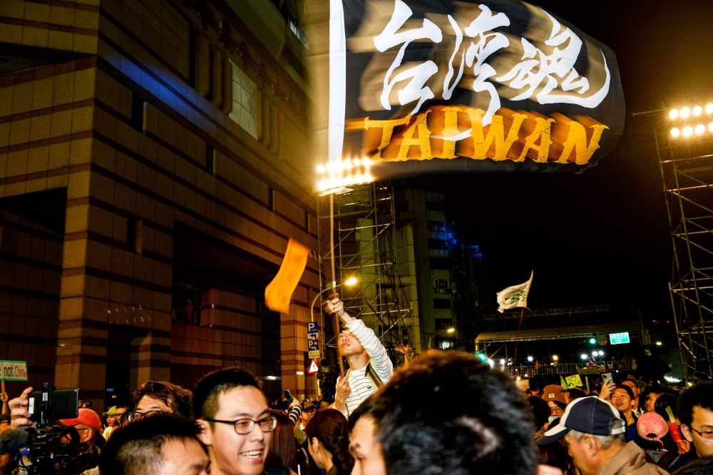 Supporters celebrate the poll victory of Taiwan's President Tsai Ing-wen and chant slogans in support of pro-democracy protesters in Hong Kong, outside the Democratic Progressive Party's headquarters as results came in for the general election in Taipei o