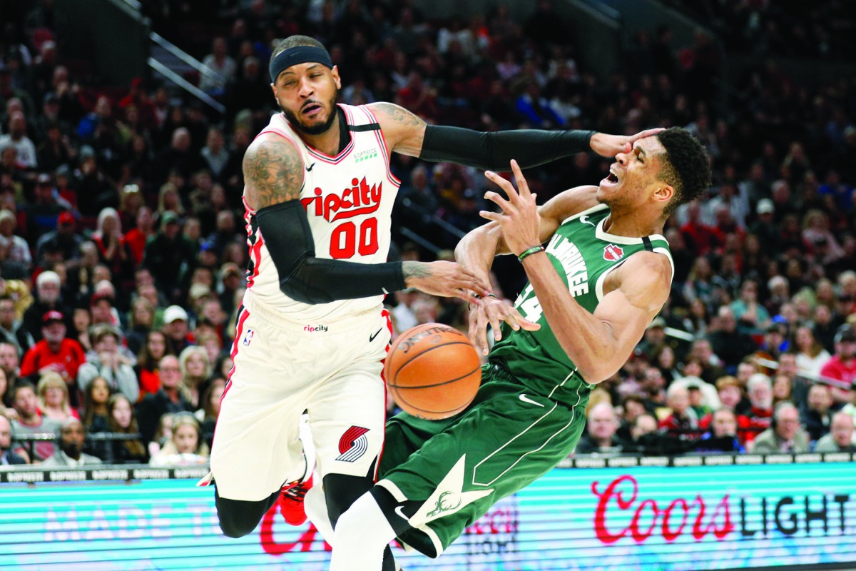 Milwaukee Bucks power forward Giannis Antetokounmpo (34) is fouled by Portland Trail Blazers power forward Carmelo Anthony (left) while driving to the basket during the first half at Moda Center, Jan 11, 2020; Portland, Oregon. Credit: Soobum Im-USA TODAY