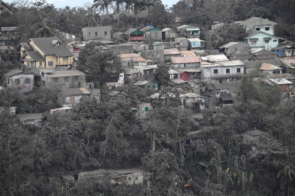 A general view of houses with roofs covered with ash, spewed by Taal volcano in Tagaytay city, south of Manila on January 14, 2020. AFP / Ted ALJIBE