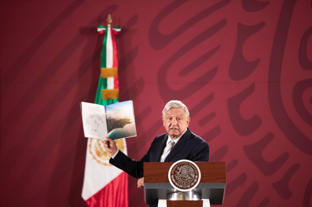 Mexico's President Andres Manuel Lopez Obrador shows a brochure of the 787 Dreamliner belonging to the Mexican Presidency, during a news conference at the National Palace in Mexico City, Mexico January 14, 2020. Press Office Andres Manuel Lopez Obrador/Ha