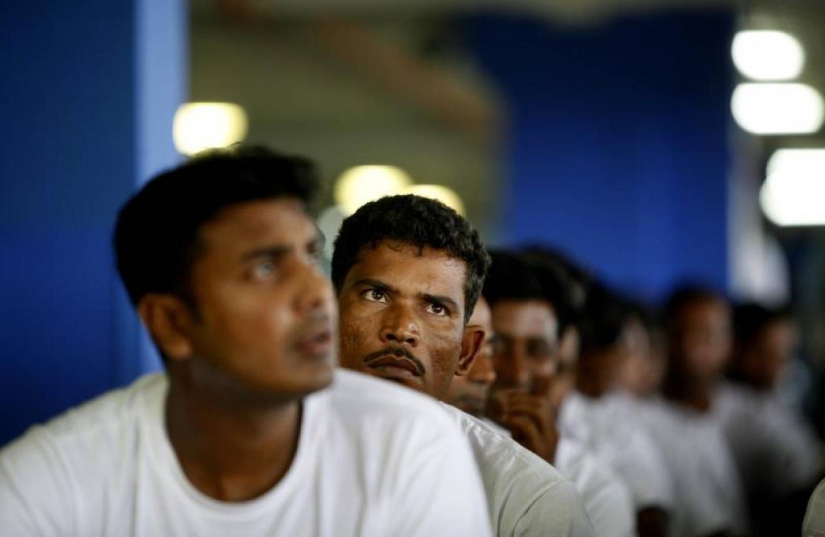 Foreign workers from Bangladesh wait at an airport carpark turned into an immigration depot in Sepang September 20, 2007. Reuters/Bazuki Muhammad