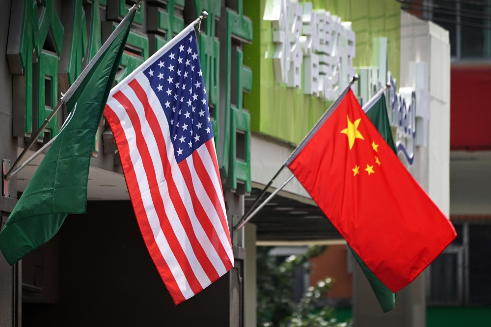 This file photo taken on May 14, 2019 shows the US and Chinese flags displayed outside a hotel in Beijing. AFP / Greg Baker