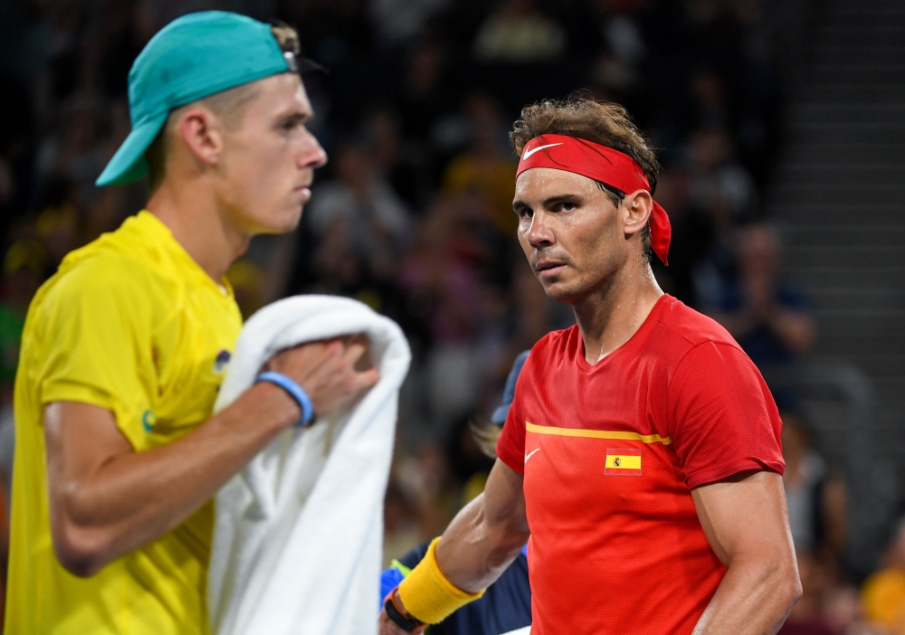 Rafael Nadal of Spain (R) walks to his end during his men's singles match against Alex de Minaur of Australia (L) at the ATP Cup tennis tournament in Sydney on January 11, 2020. (AFP / William WEST )