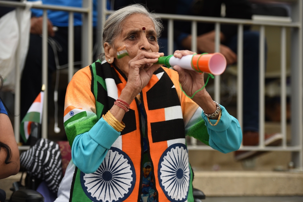 In this file photo taken on July 9, 2019, India's cricket team supporter, 87 year old Charulata Patel cheers on her team during the 2019 cricket World Cup first semi-final between India and New Zealand / AFP / Oli SCARFF /