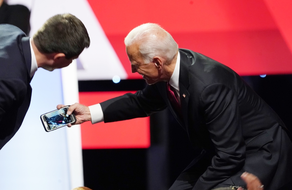 Pete Buttigieg leans in to a selfie by Joe Biden with the crowd at the end of the fourth US Democratic presidential candidates 2020 election debate at Otterbein University, October 15, 2019. Reuters /  Shannon Stapleton