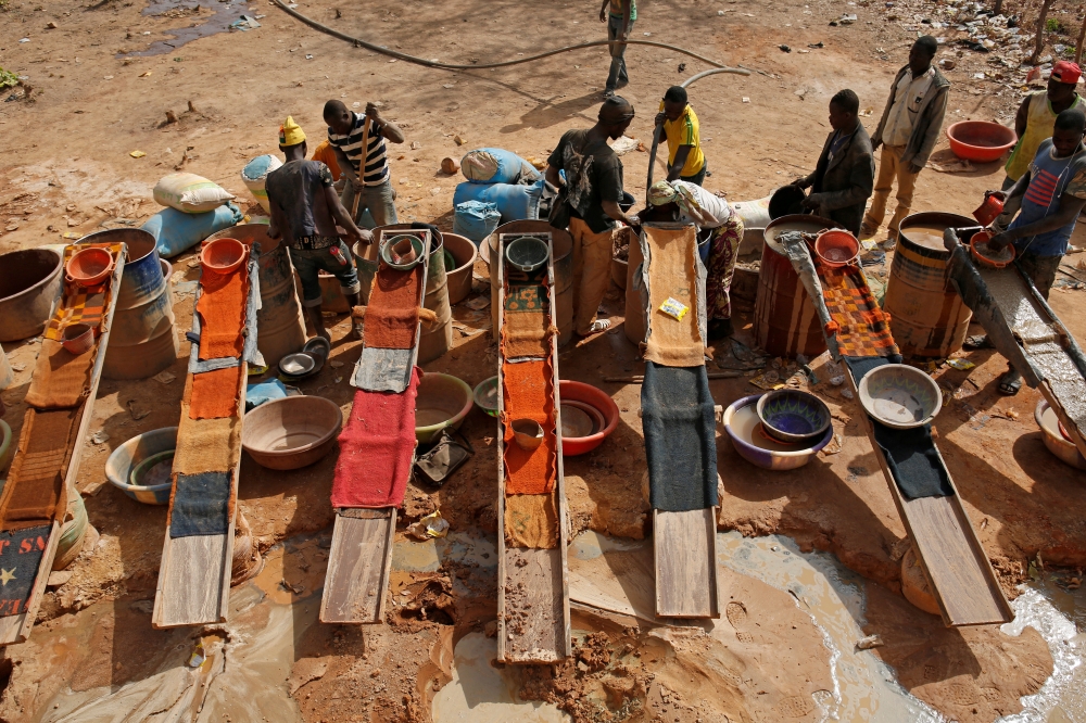 Artisanal miners sluice for gold by pouring water through gravel at an unlicensed mine near the city of Doropo, Ivory Coast, February 13, 2018. Reuters/Luc Gnago