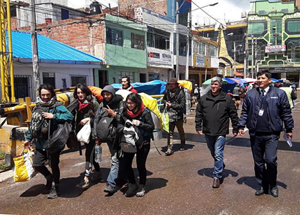 Tourists being escorted by authorities as they walk towards the borderline with Bolivia in Desaguadero, Peru, on January 16, 2010, after they were arrested for surreptitiously entering prohibited areas of the ancient Inca citadel of Machu Picchu, and dama