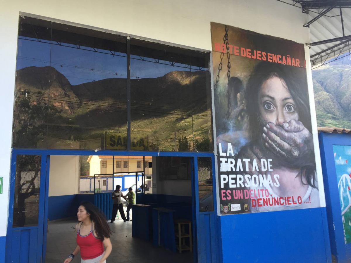 A mural outside a bus station warns of the dangers of human trafficking, Calca, Peru. December 1, 2019. Thomson Reuters Foundation/Anastasia Moloney