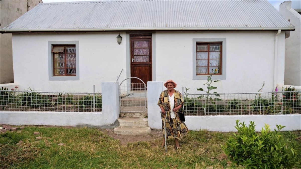 Pauline Cloete poses in front of her house for a photo in Elim in the Western Cape, South Africa, 11 December 2019. Thomson Reuters Foundation/Kim Harrisberg