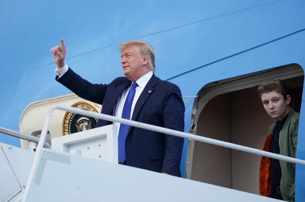 U.S. President Donald Trump and his son Barron step out from Air Force One upon arrival in West Palm Beach, Florida, U.S., January 17, 2020. REUTERS/Kevin Lamarque