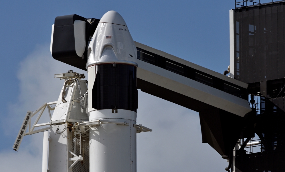 The SpaceX Crew Dragon capsule sits atop a Falcon 9 booster rocket on Pad 39A at Kennedy Space Center after a scheduled in-flight abort test was postponed due to poor weather offshore at Cape Canaveral, Florida, U.S. January 18, 2020. REUTERS/Steve Nesius