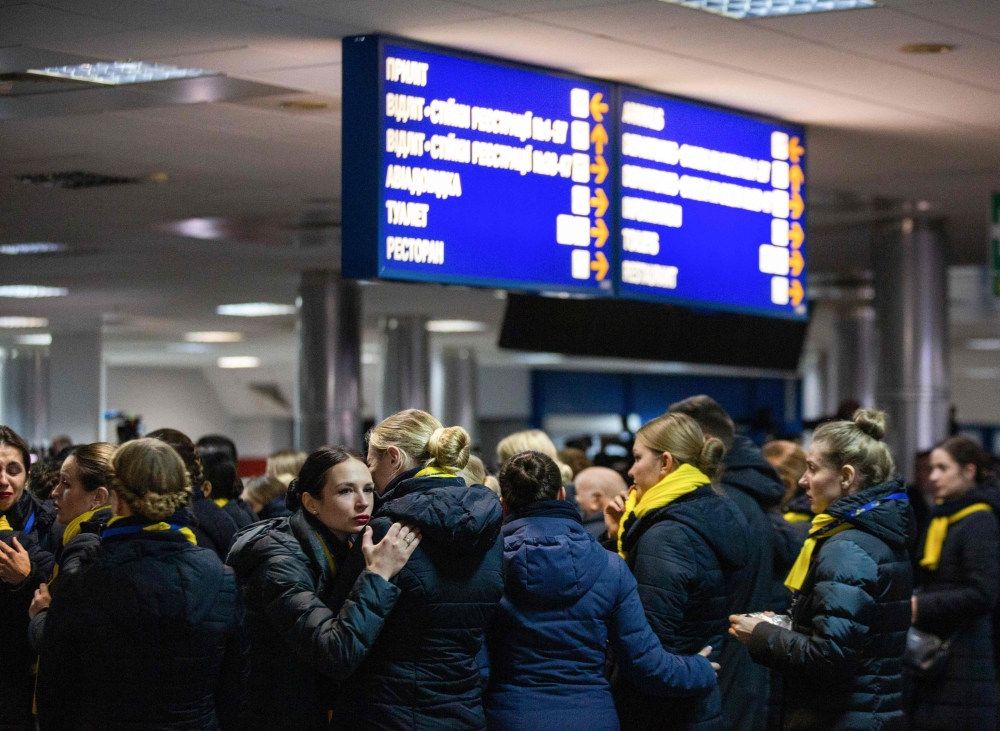 Relatives and colleagues during a tribute ceremony for the 11 Ukrainians who died in a plane mistakenly shot down by Iran during a spike in tensions with Washington, at Kiev's Boryspil airport, on January 19, 2020. 