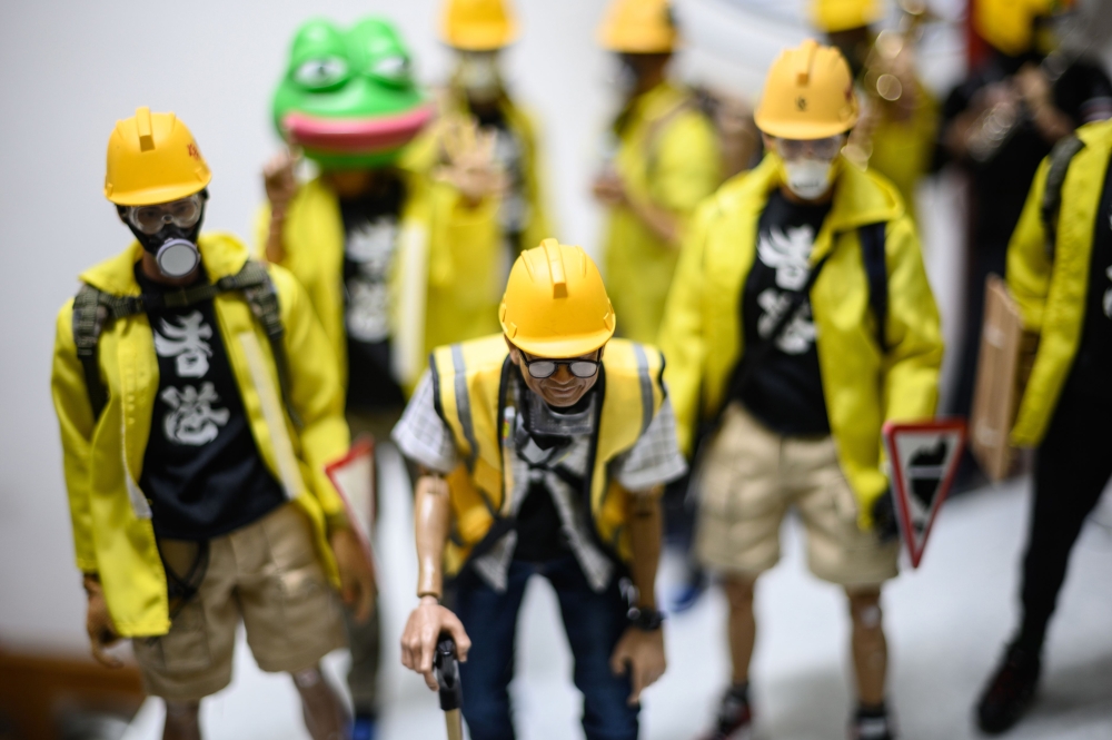 This picture taken on January 14, 2020, shows 1:6 scale action figures depicting characters involved in the Hong Kong protests, in Hong Kong. AFP / Philip Fong 