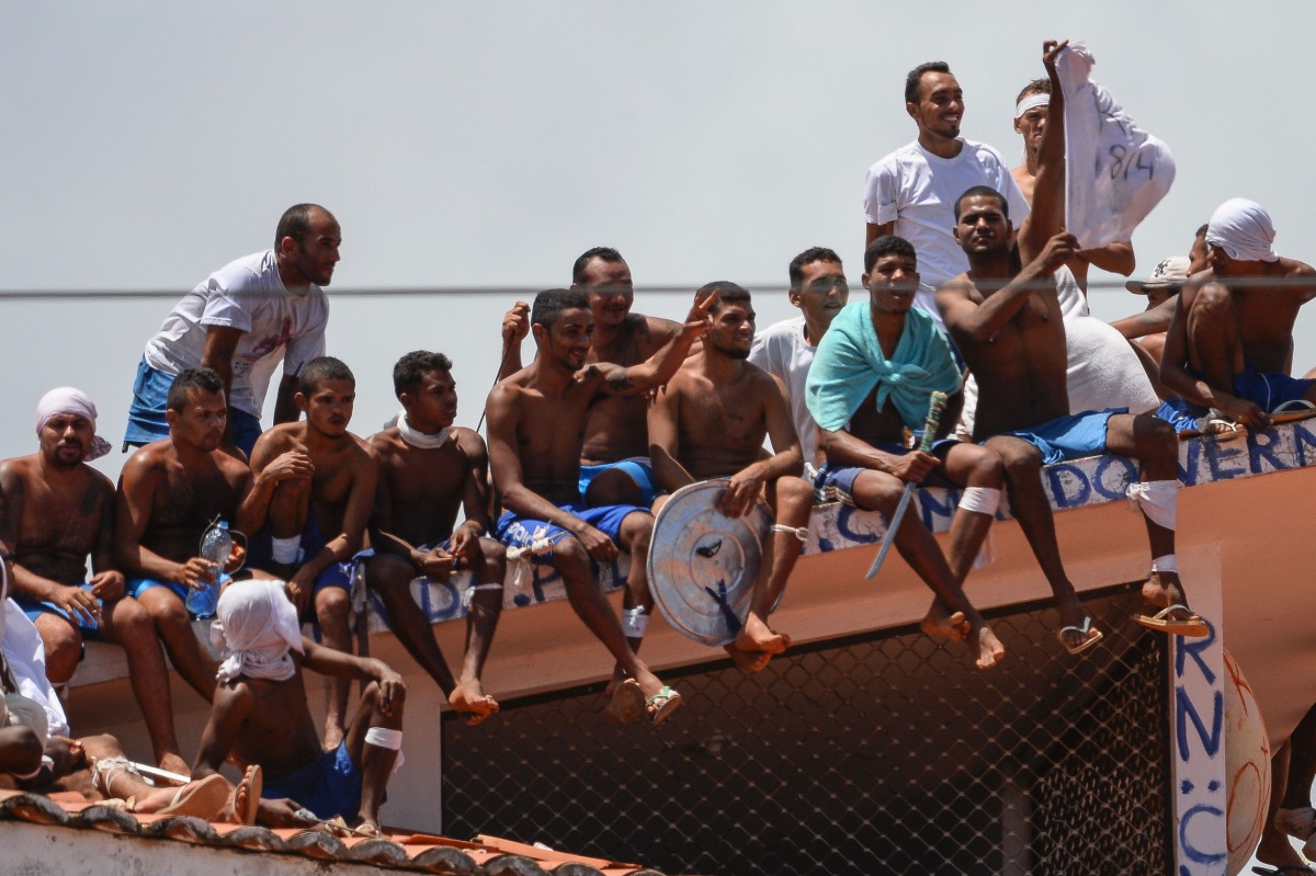 File photo: Inmates stand on the prison roof during a rebellion in Alcacuz Penitentiary Center near Natal, Rio Grande do Norte state, northeastern Brazil on January 16, 2017. AFP / Andressa Anholete