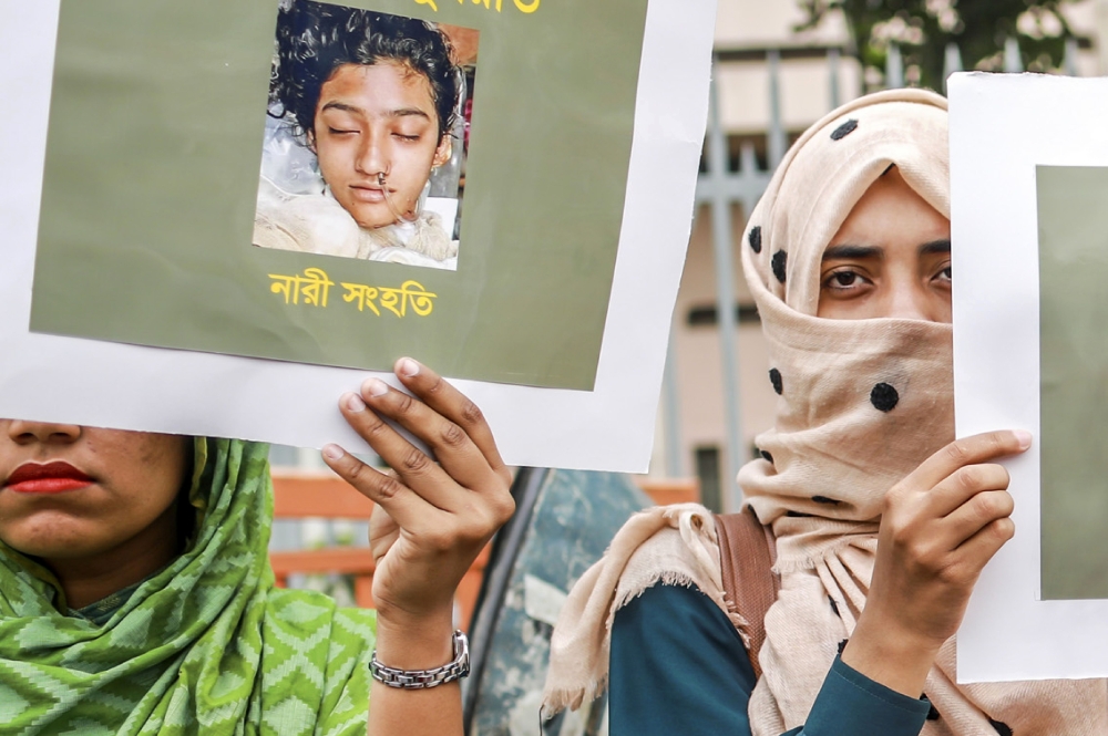 Bangladeshi women hold placards and photographs of schoolgirl Nusrat Jahan Rafi at a protest in Dhaka following her murder after she had reported a sexual assault on April 12, 2019. AFP  / Sazzad Hossain