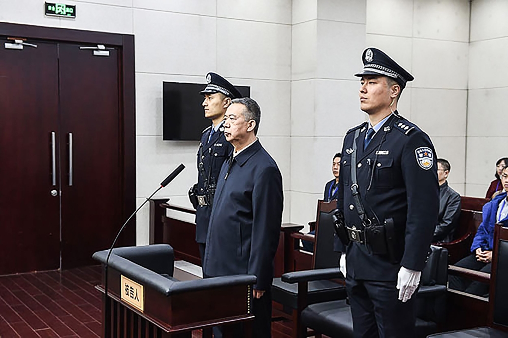 This handout photo taken on January 21, 2020 and released by the Tianjin First Intermediate People's Court shows former Interpol chief Meng Hongwei (C) during his sentencing at the court in the Chinese city of Tianjin.AFP PHOTO / TIANJIN FIRST INTERMEDIAT