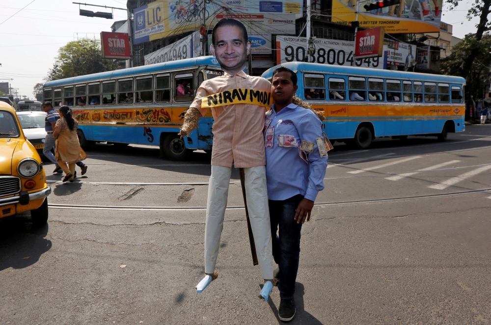 FILE PHOTO: A protester holds an effigy depicting billionaire jeweller Nirav Modi during a rally in Kolkata, India, February 18, 2018. REUTERS/Rupak De Chowdhuri