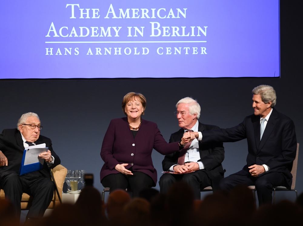 Former US Secretary of State Henry A. Kissinger, German Chancellor Angela Merkel, former president of Stanford University Gerhard Casper and former U.S. Secretary of State John Kerry attend the American Academy's award ceremony at the Charlottenburg Palac