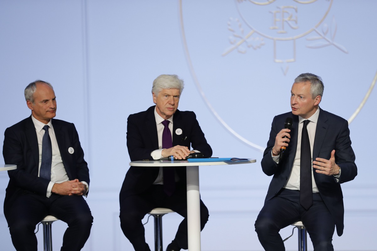 French Economy and Finance Minister Bruno Le Maire (R) delivers a speech next to Arnaud Vaissie (C) CEO and co-founder of medical and travel security services firm, International SOS and Olivier Schiller (L), CEO of Septodont during a gathering of 500 bus