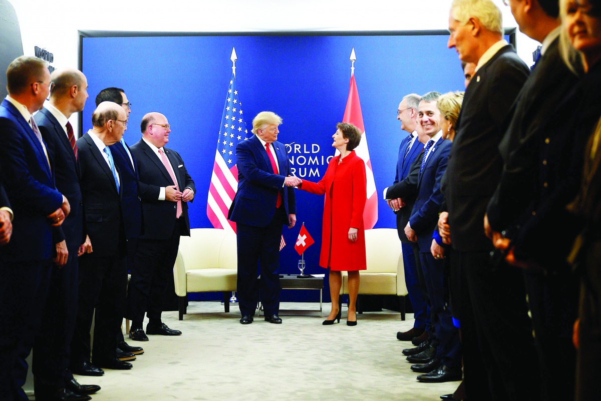 US President Donald Trump (C,L) shakes hands with Swiss Confederation President Simonetta Sommaruga ahead of their meeting at the World Economic Forum in Davos, on January 21, 2020. AFP / Jim Watson

