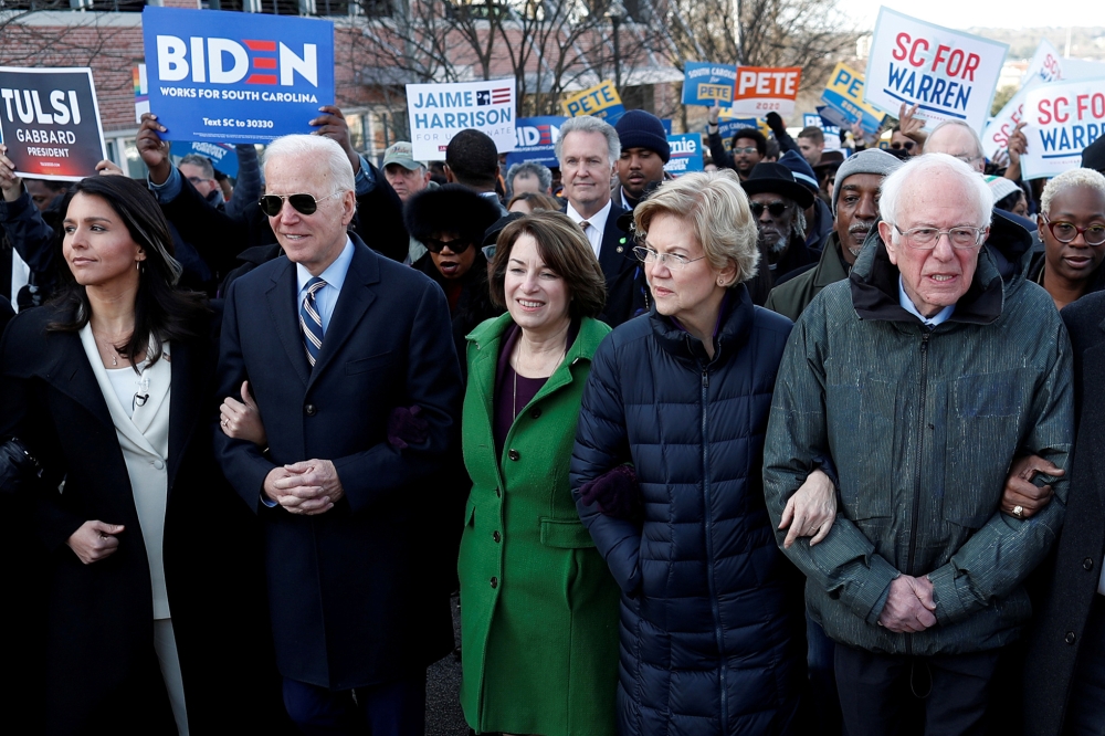 Democratic 2020 U.S. presidential candidates Rep. Tulsi Gabbard, former U.S. Vice President Joe Biden, Senator Amy Klobuchar, Senator Elizabeth Warren and Senator Bernie Sanders, walk arm-in-arm with local African-American leaders during the Martin Luther