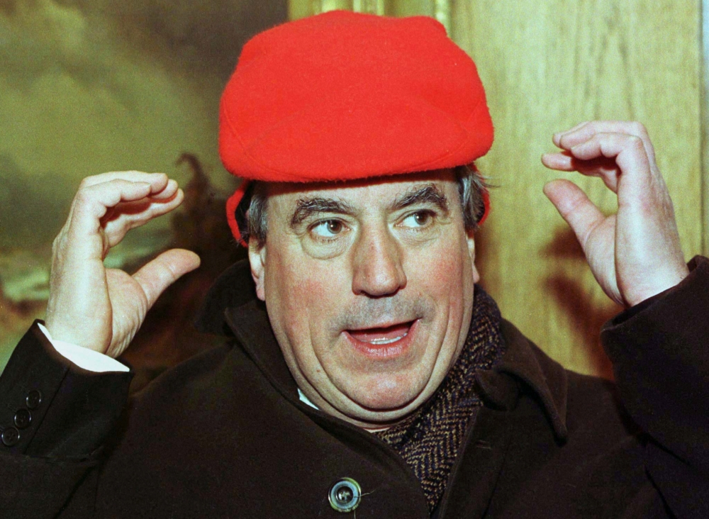 Terry Jones, one of the original Monty Python British comedy troupe members, tries to adjust a winter hat that is just a little bit too small for his head. Reuters file photo / Gary Caskey 