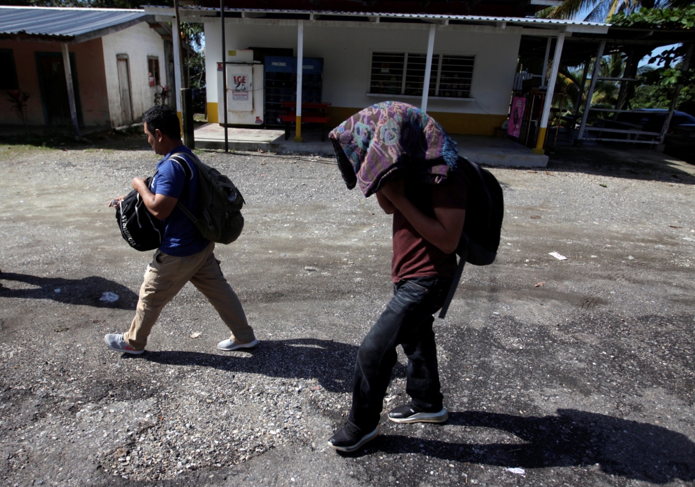 Honduran migrants walk after arriving on some buses with people of a caravan after being deported from Mexico, in Corinto, Honduras, January 22, 2020. REUTERS/Jorge Cabrera